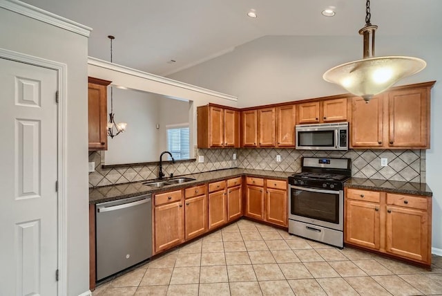 kitchen with hanging light fixtures, sink, light tile patterned flooring, lofted ceiling, and stainless steel appliances