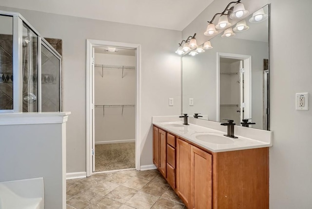 bathroom featuring vanity, tile patterned floors, and a shower with door