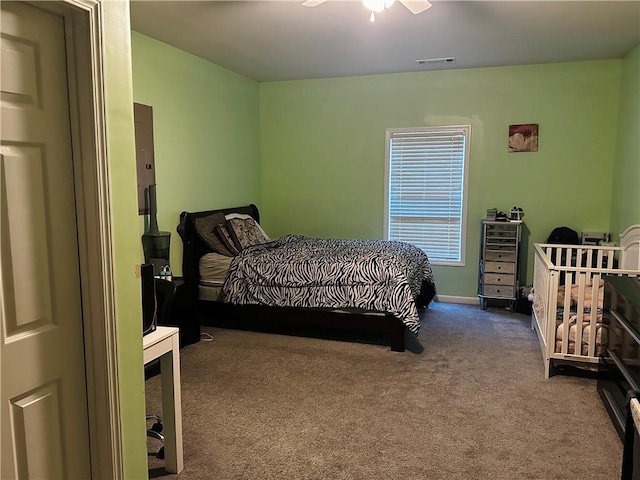 bedroom featuring ceiling fan and carpet