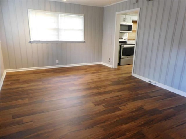 893 Andrews Dr, Conyers, GA 30012 - spare room featuring dark wood finished floors and baseboards