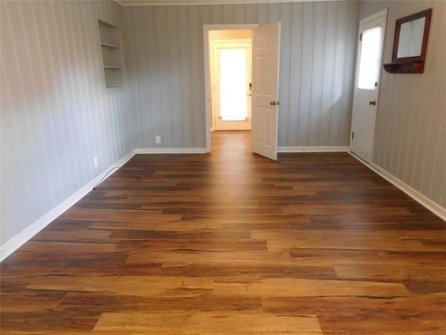 893 Andrews Dr, Conyers, GA 30012 - empty room featuring wood finished floors, baseboards, and built in features