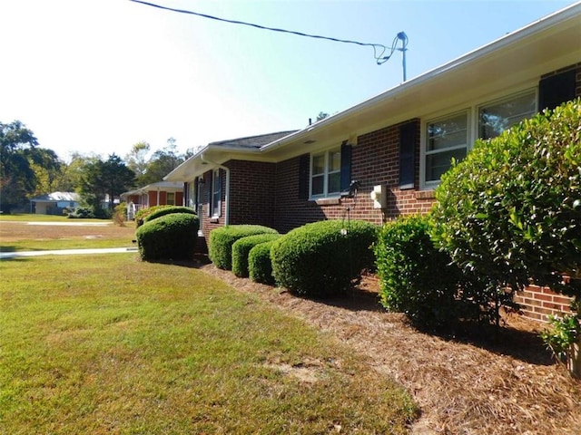 893 Andrews Dr, Conyers, GA 30012 - view of side of property with brick siding and a lawn