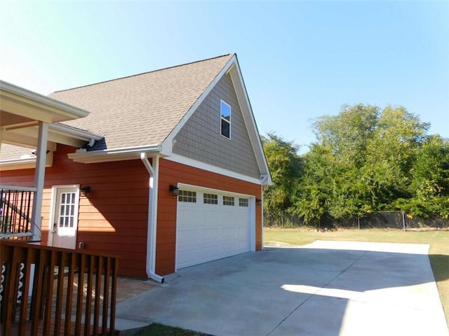 893 Andrews Dr, Conyers, GA 30012 - view of property exterior with roof with shingles, driveway, and a detached garage