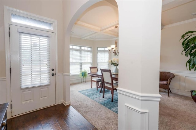 foyer featuring beam ceiling, a chandelier, coffered ceiling, crown molding, and dark hardwood / wood-style flooring