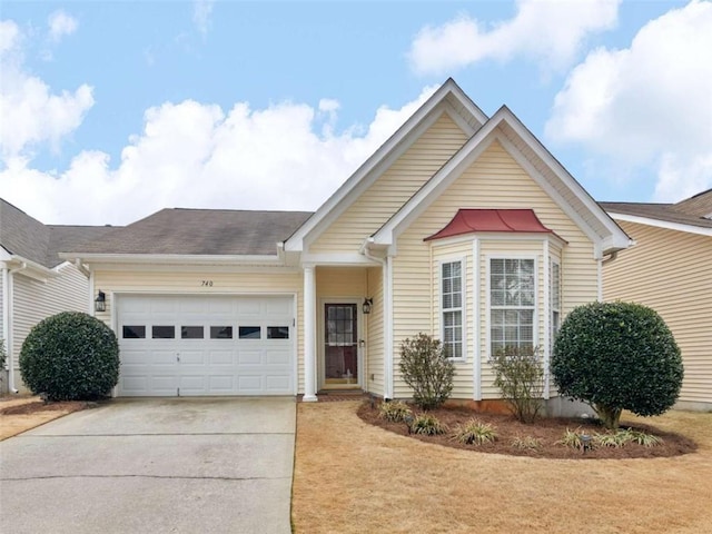 single story home featuring concrete driveway, an attached garage, a front yard, and a shingled roof