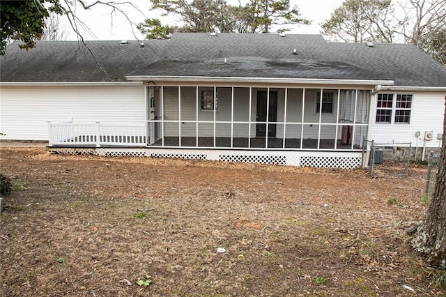 rear view of property featuring a sunroom