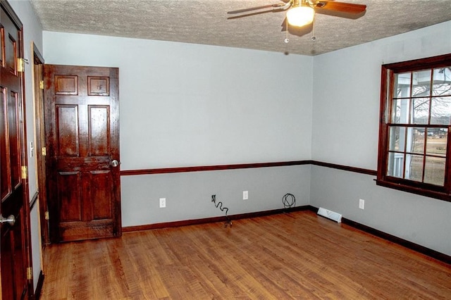 spare room featuring ceiling fan, a textured ceiling, and hardwood / wood-style flooring