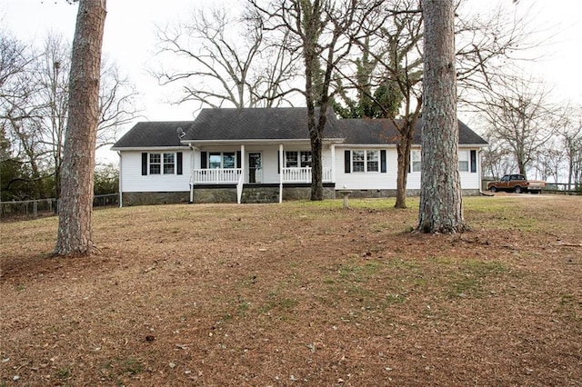 ranch-style house with a front lawn and covered porch