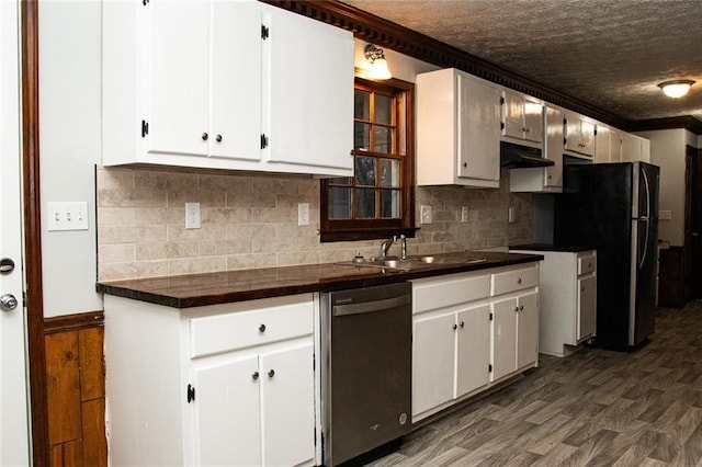 kitchen with exhaust hood, white cabinetry, stainless steel dishwasher, and sink