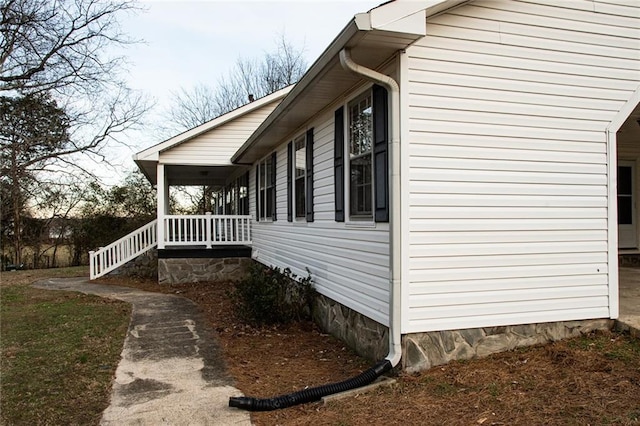 view of property exterior featuring covered porch