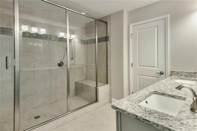 bathroom featuring vanity, tile patterned flooring, and a shower with shower door