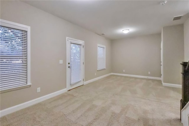 unfurnished living room featuring light colored carpet