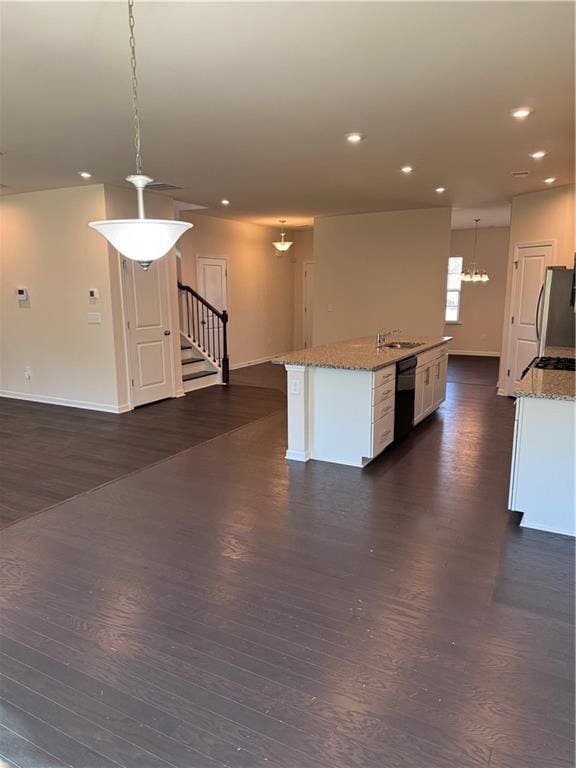 136 Paulownia Cir, Mcdonough, GA 30253 - kitchen featuring freestanding refrigerator, dishwasher, dark wood-type flooring, recessed lighting, and a kitchen island with sink