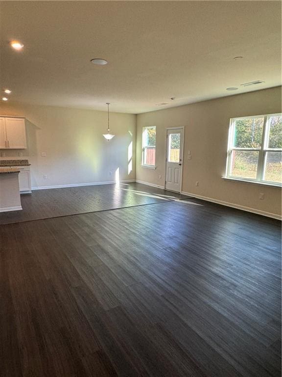 136 Paulownia Cir, Mcdonough, GA 30253 - unfurnished living room with dark wood-style flooring and recessed lighting