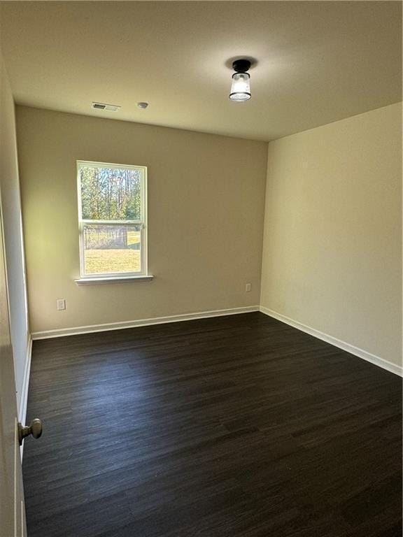 136 Paulownia Cir, Mcdonough, GA 30253 - spare room with dark wood-style flooring and baseboards