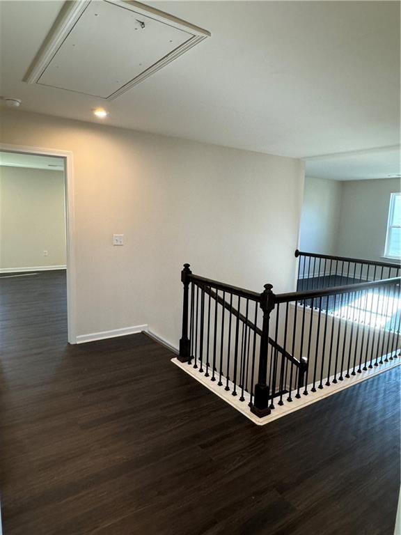 136 Paulownia Cir, Mcdonough, GA 30253 - hallway featuring attic access, dark wood-type flooring, recessed lighting, and an upstairs landing