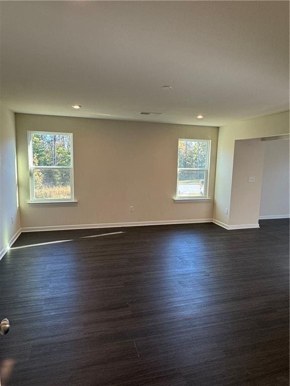 136 Paulownia Cir, Mcdonough, GA 30253 - spare room featuring dark wood-style floors, healthy amount of natural light, and recessed lighting