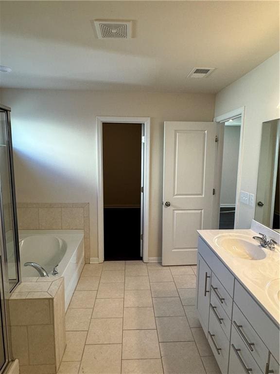 136 Paulownia Cir, Mcdonough, GA 30253 - bathroom featuring double vanity, a garden tub, tile patterned flooring, and a shower with shower door