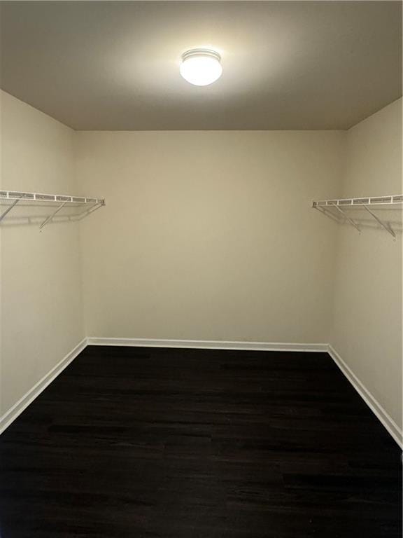 136 Paulownia Cir, Mcdonough, GA 30253 - walk in closet featuring dark wood-style flooring