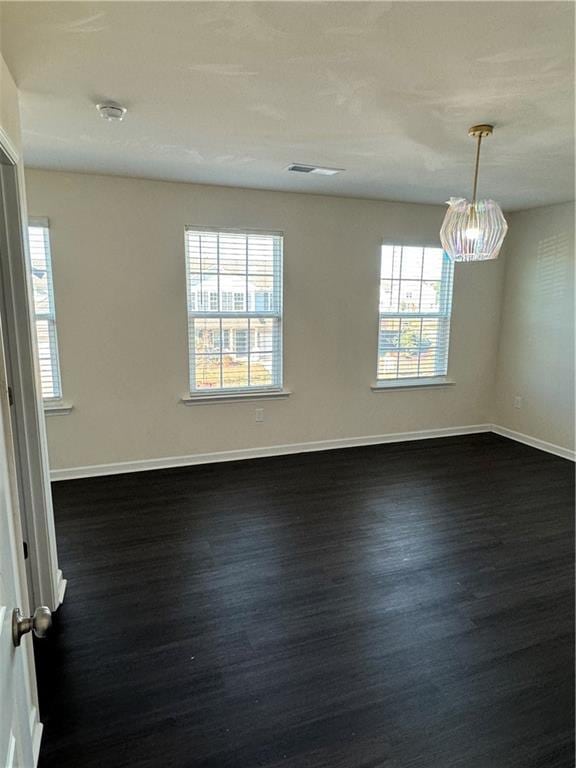 136 Paulownia Cir, Mcdonough, GA 30253 - unfurnished room featuring dark wood-style flooring, healthy amount of natural light, and a smoke detector