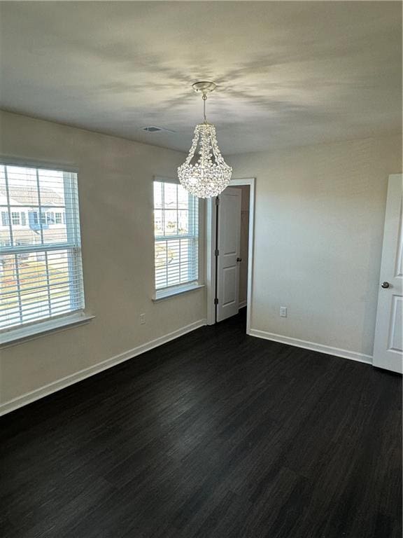 136 Paulownia Cir, Mcdonough, GA 30253 - unfurnished dining area featuring a chandelier and dark wood-type flooring