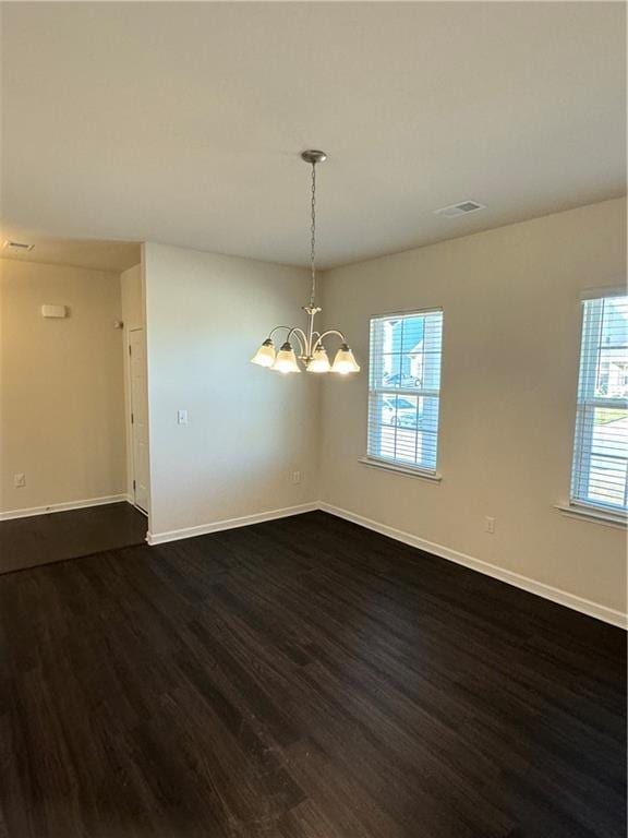 136 Paulownia Cir, Mcdonough, GA 30253 - spare room featuring dark wood-style flooring and a chandelier