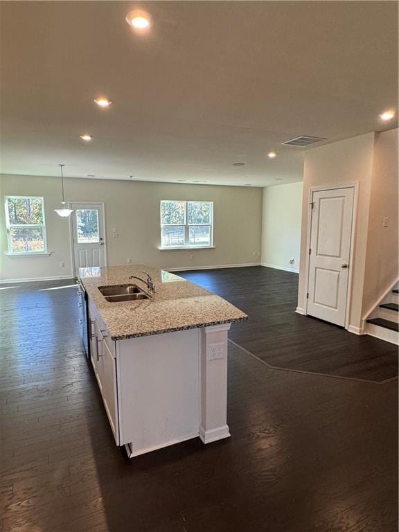 136 Paulownia Cir, Mcdonough, GA 30253 - kitchen with dark wood-style floors, white cabinetry, recessed lighting, light stone counters, and open floor plan