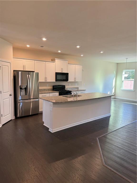 136 Paulownia Cir, Mcdonough, GA 30253 - kitchen featuring black appliances, white cabinetry, dark wood finished floors, and recessed lighting