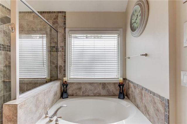 bathroom featuring independent shower and bath