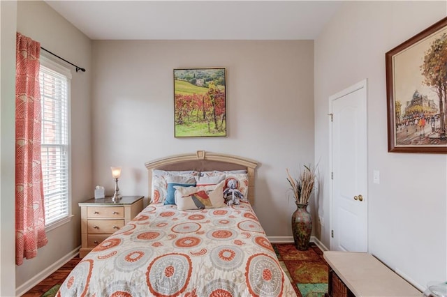 bedroom with dark wood-type flooring