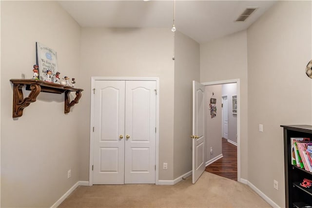 hall featuring light colored carpet