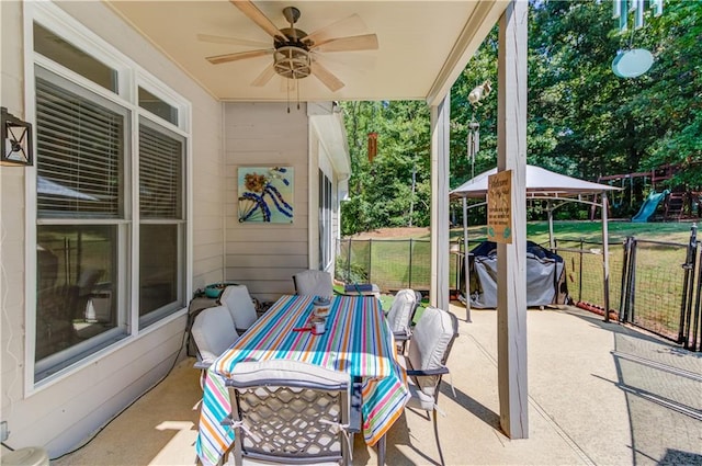 view of patio featuring a gazebo, a playground, and ceiling fan