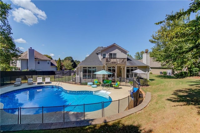 view of swimming pool with a lawn and a patio