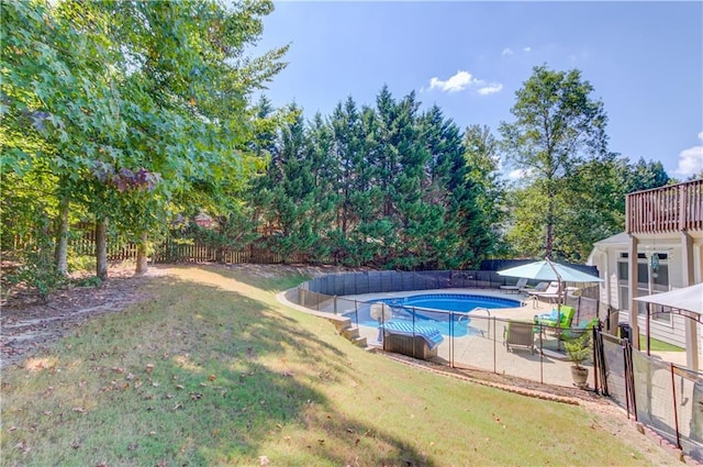 view of pool featuring a lawn