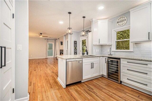 4272 Glenlake Dr NW, Kennesaw, GA 30144 - kitchen with stainless steel dishwasher, beverage cooler, a sink, a peninsula, and decorative backsplash
