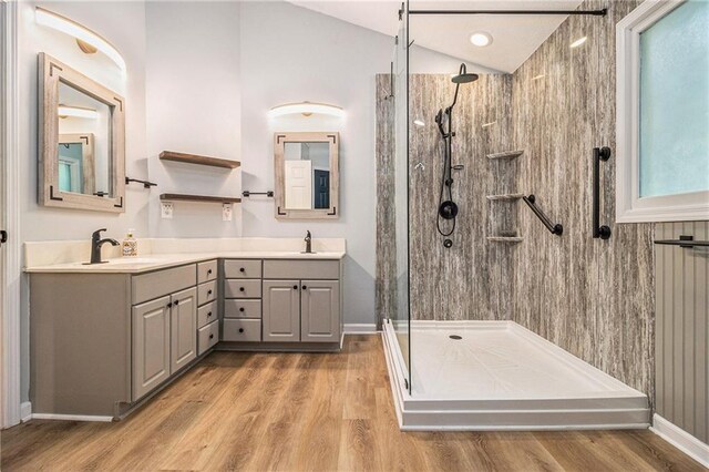 4272 Glenlake Dr NW, Kennesaw, GA 30144 - bathroom with a walk in shower, double vanity, wood finished floors, baseboards, and vaulted ceiling