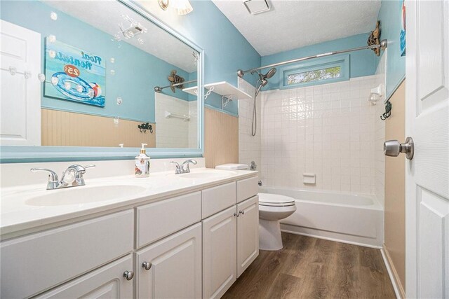 4272 Glenlake Dr NW, Kennesaw, GA 30144 - full bathroom featuring toilet, wood finished floors, shower / bath combination, double vanity, and a textured ceiling
