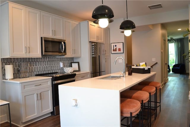 1350 May Ave Unit 14, Atlanta, GA 30316 - kitchen with a sink, a kitchen island with sink, tasteful backsplash, appliances with stainless steel finishes, and dark wood-style floors