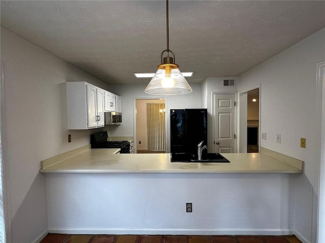 1101 Lenox Way NE Unit 1101, Atlanta, GA 30324 - kitchen featuring black appliances, a peninsula, light countertops, white cabinetry, and a textured ceiling