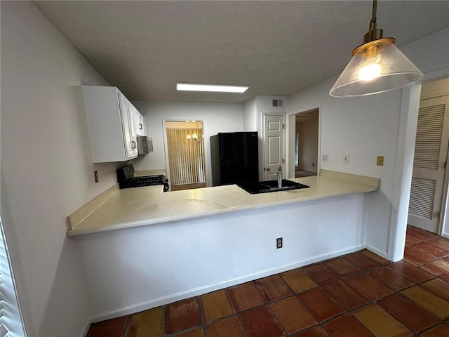 1101 Lenox Way NE Unit 1101, Atlanta, GA 30324 - kitchen with a sink, black appliances, a peninsula, light countertops, and a textured ceiling