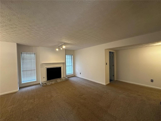 1101 Lenox Way NE Unit 1101, Atlanta, GA 30324 - unfurnished living room with dark carpet, a textured ceiling, baseboards, and a fireplace with raised hearth