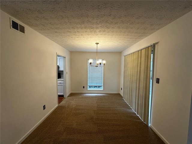 1101 Lenox Way NE Unit 1101, Atlanta, GA 30324 - hallway with a chandelier, baseboards, dark carpet, and a textured ceiling