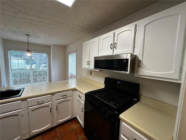 1101 Lenox Way NE Unit 1101, Atlanta, GA 30324 - kitchen with stainless steel microwave, black gas range oven, healthy amount of natural light, a textured ceiling, and white cabinets