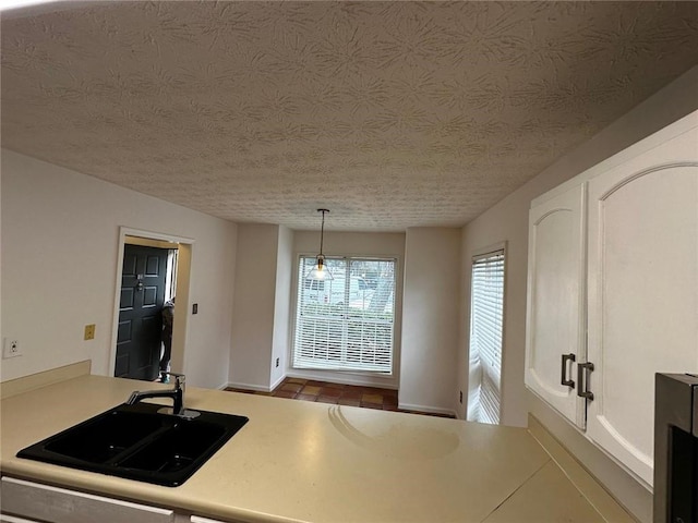 1101 Lenox Way NE Unit 1101, Atlanta, GA 30324 - kitchen featuring a sink, light countertops, white cabinets, baseboards, and a textured ceiling