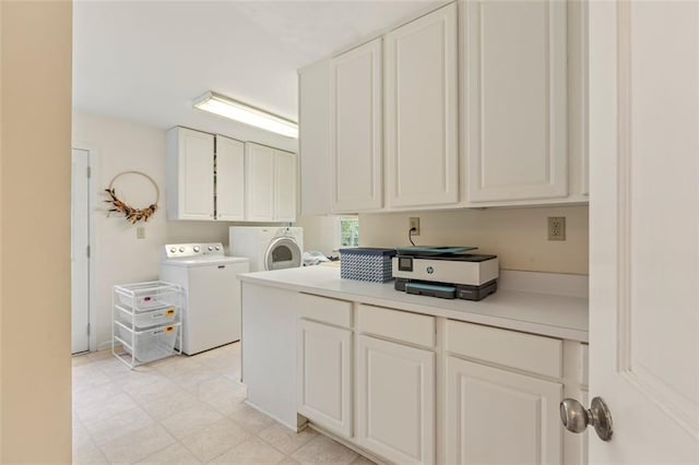 washroom featuring independent washer and dryer and cabinet space