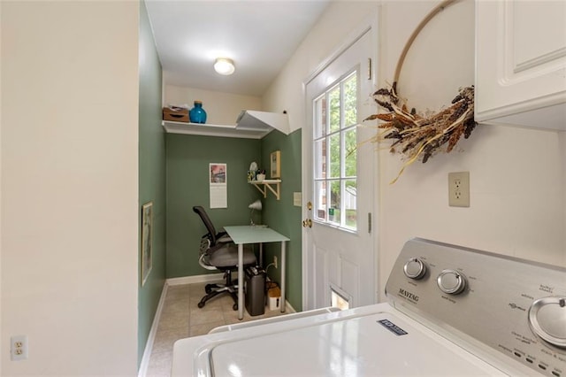 clothes washing area featuring washer / dryer, tile patterned floors, cabinet space, baseboards, and an office area