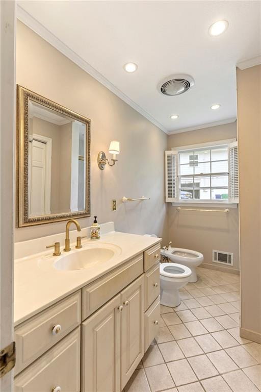 bathroom featuring crown molding, a bidet, vanity, toilet, and tile patterned floors
