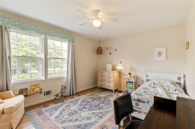 bedroom with multiple windows, baseboards, and ceiling fan