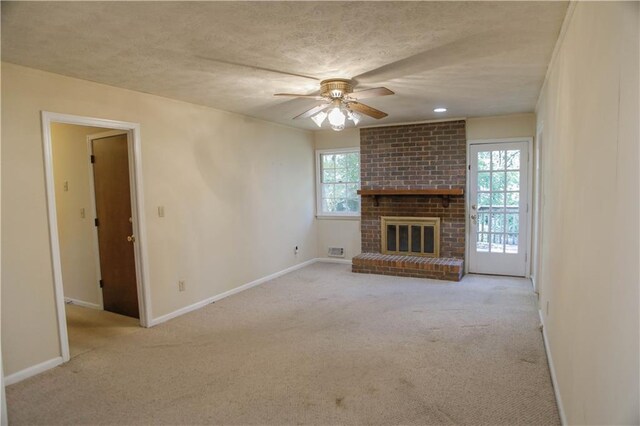 unfurnished living room featuring light carpet, a wealth of natural light, and a brick fireplace