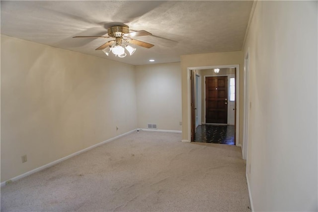 carpeted empty room featuring ceiling fan